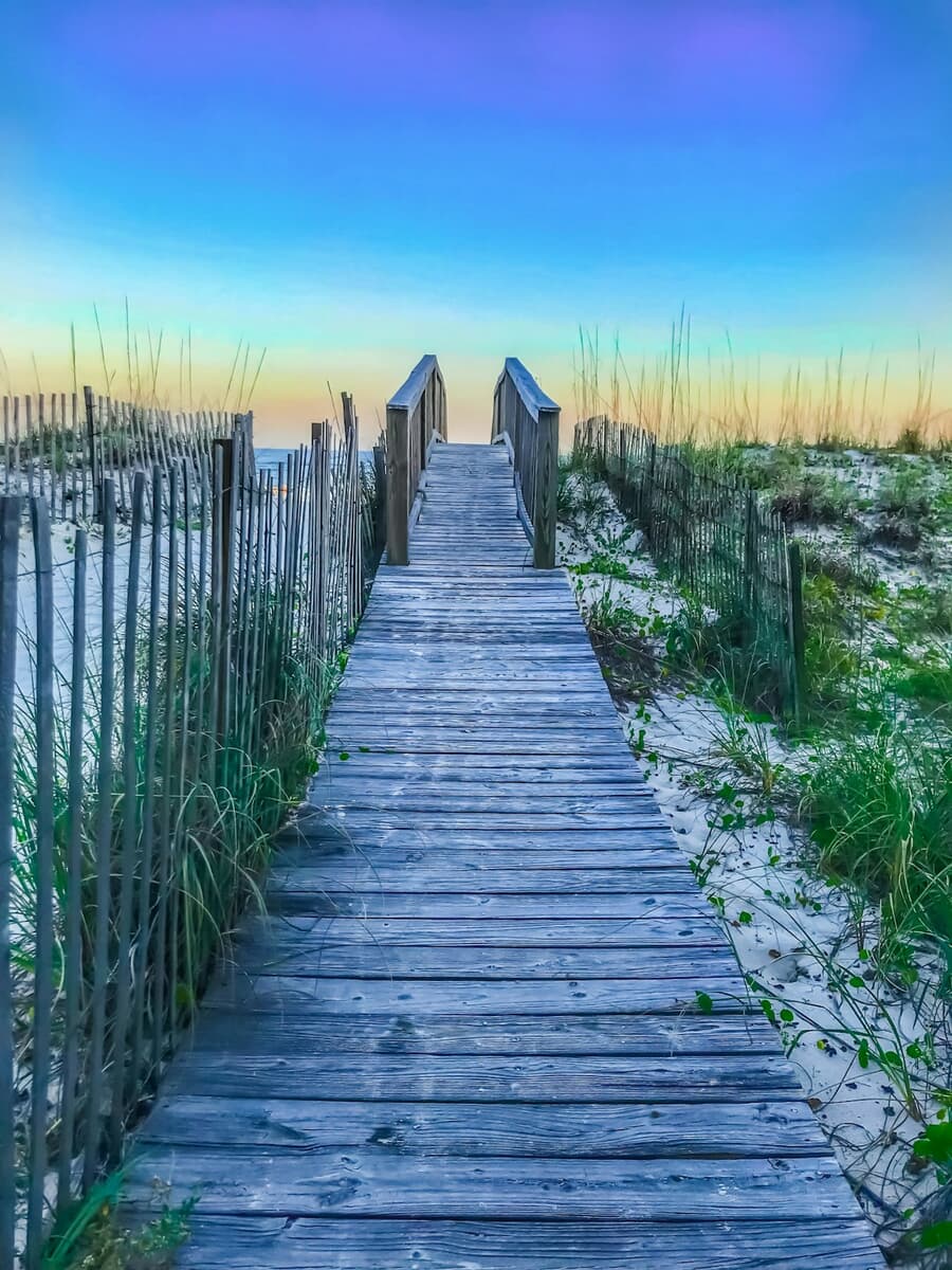 Wooden boardwalk over the dunes to the beach at Gulf Shores, Alabama