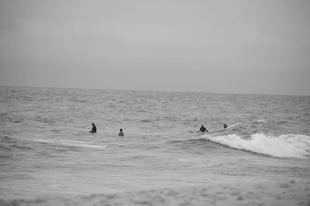 Surfers in the water at dawn off Seaside Heights on the Jersey Shore