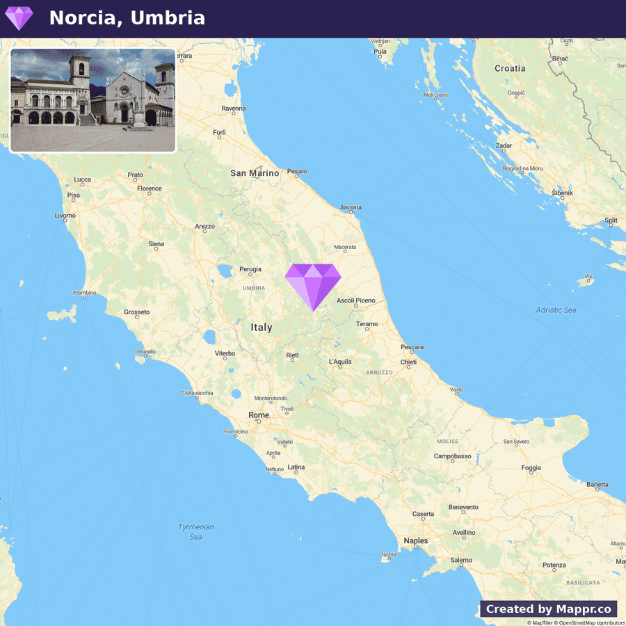 A map highlighting the location of Norcia in Umbria, Italy, with a photo inset showing a square with historical buildings in Norcia.