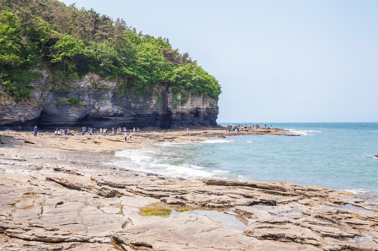 A coastal scene with layered rock formations at Chaeseokgang, South Korea