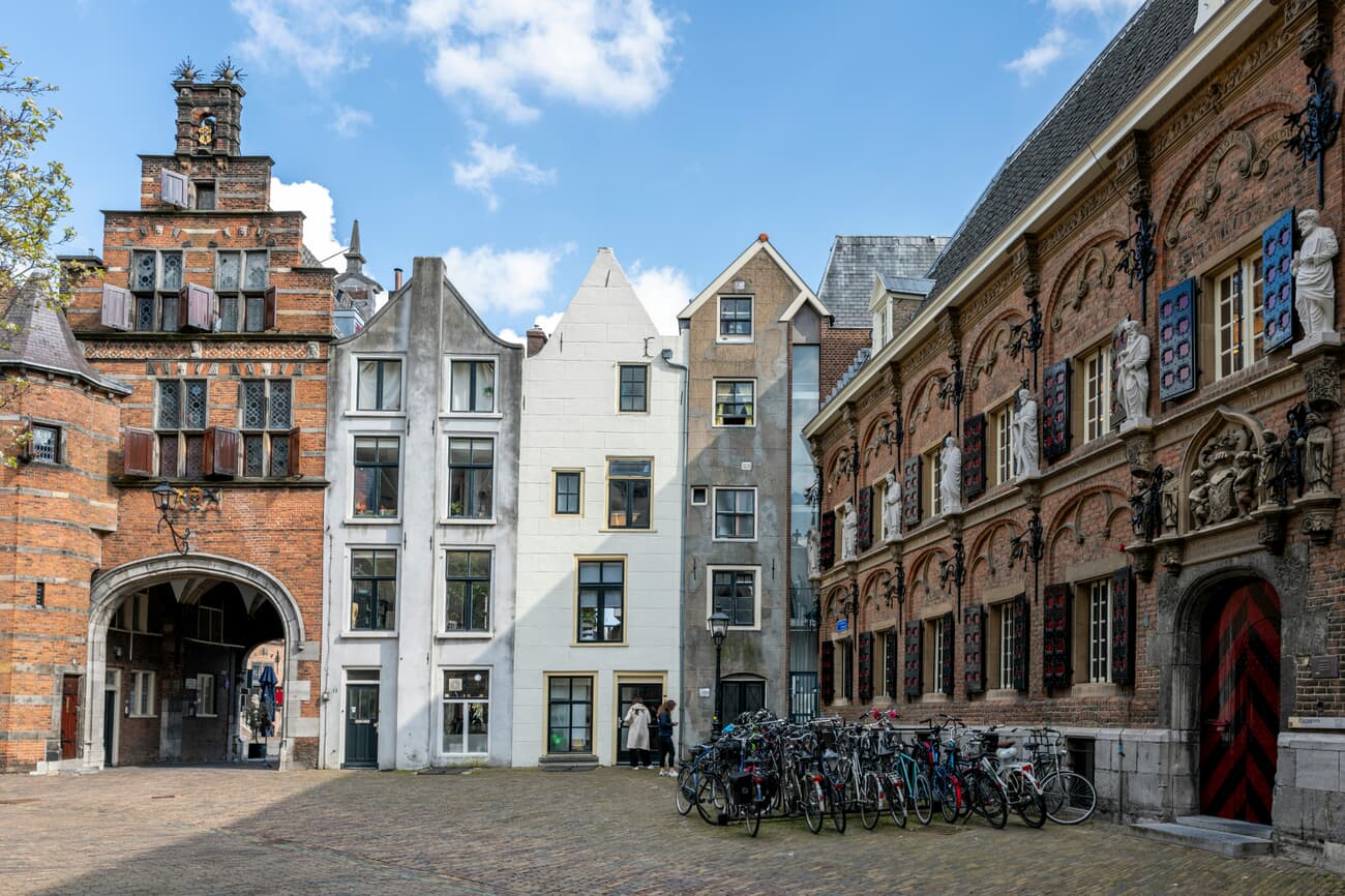 Cobbled streets of Nijmegen's old town with the Waal river in the background.