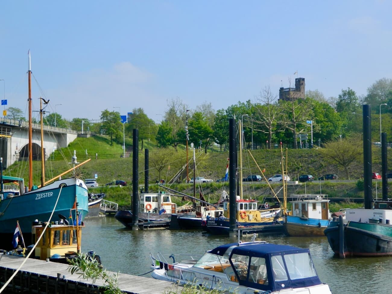 Cobbled streets of Nijmegen's old town with the Waal river in the background.