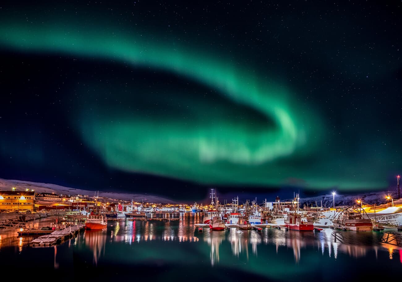Båtsfjord's frontier, where the midnight sun illuminates the rugged Arctic wilderness