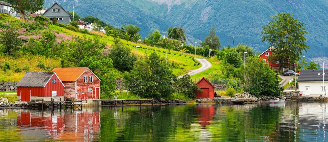 Rosendal, surrounded by mountains and fjords, with a historic manor as its centerpiece