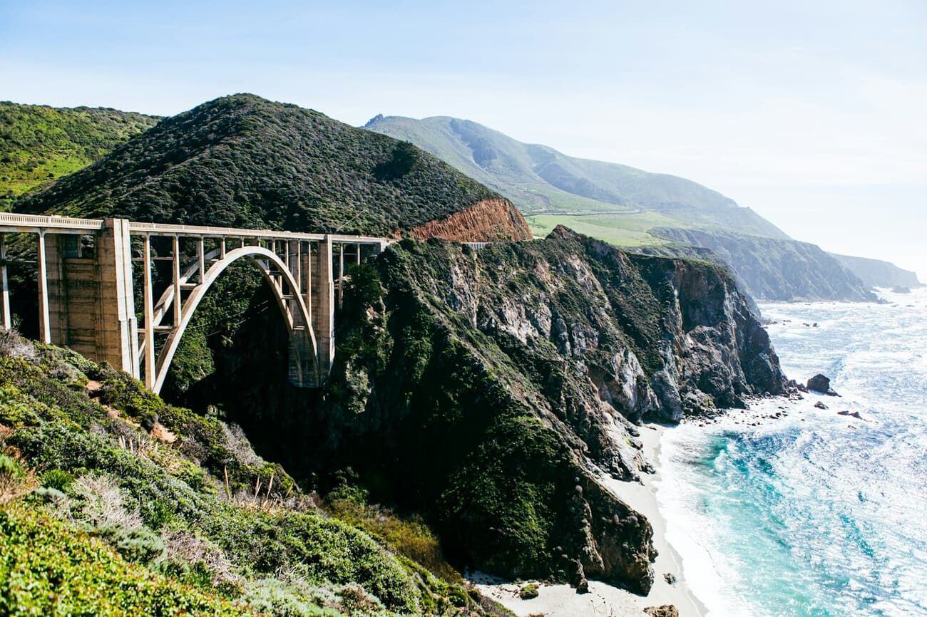 Bixby Bridge spans a turquoise cove along the Big Sur coastline in California