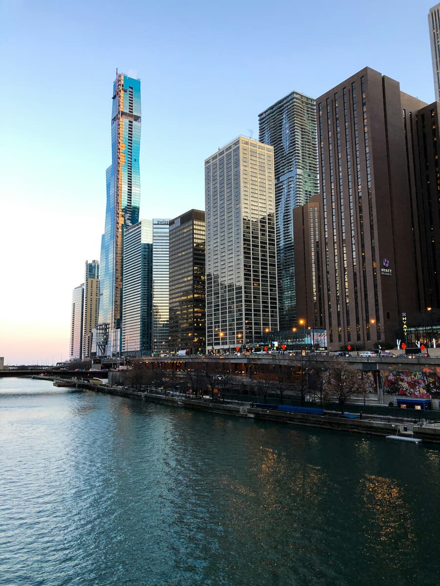 The Chicago skyline glows at dusk where the river meets the lakefront