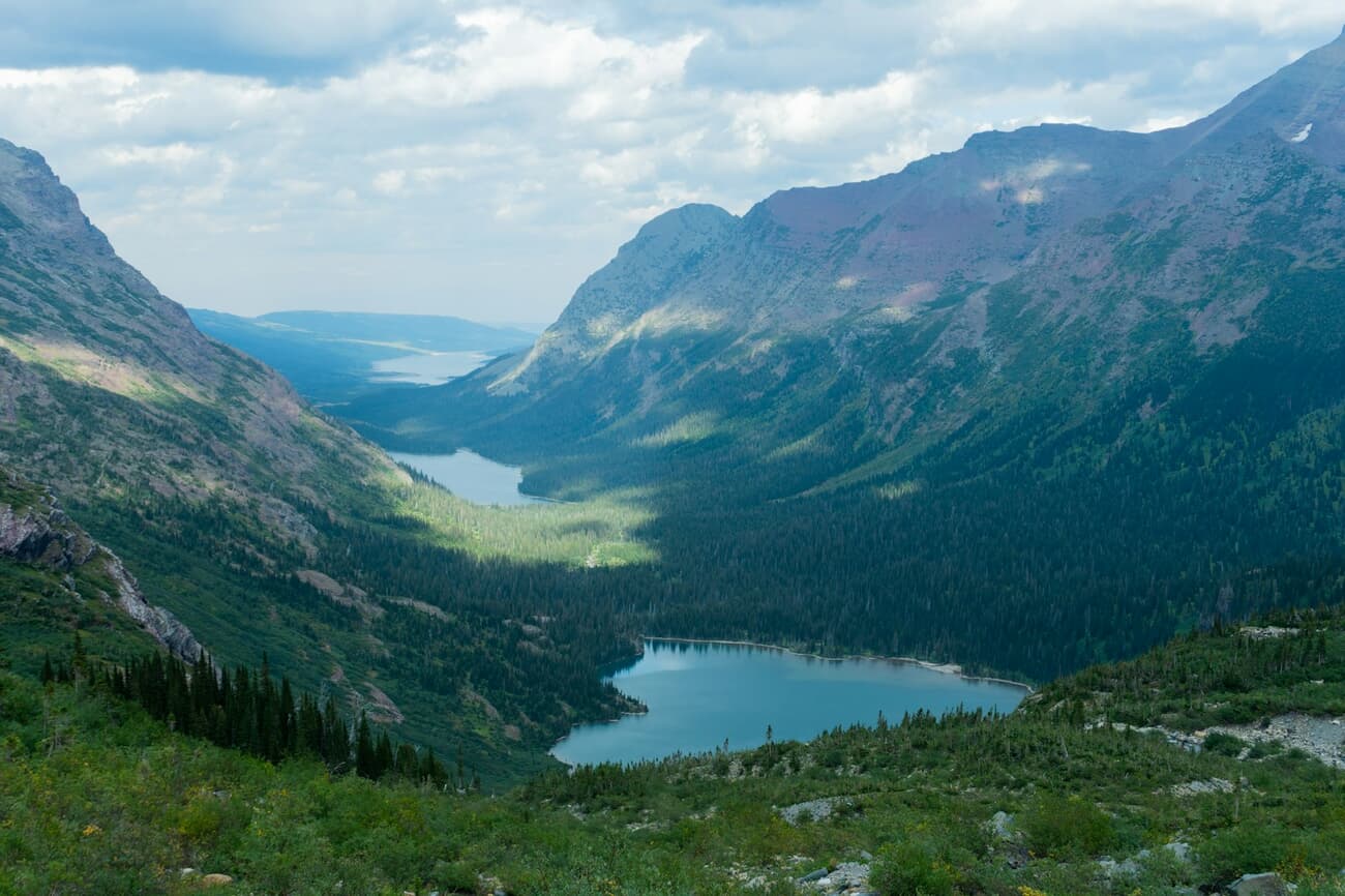 Turquoise glacial lakes stack down the valley below Grinnell Glacier in Glacier National Park, Montana