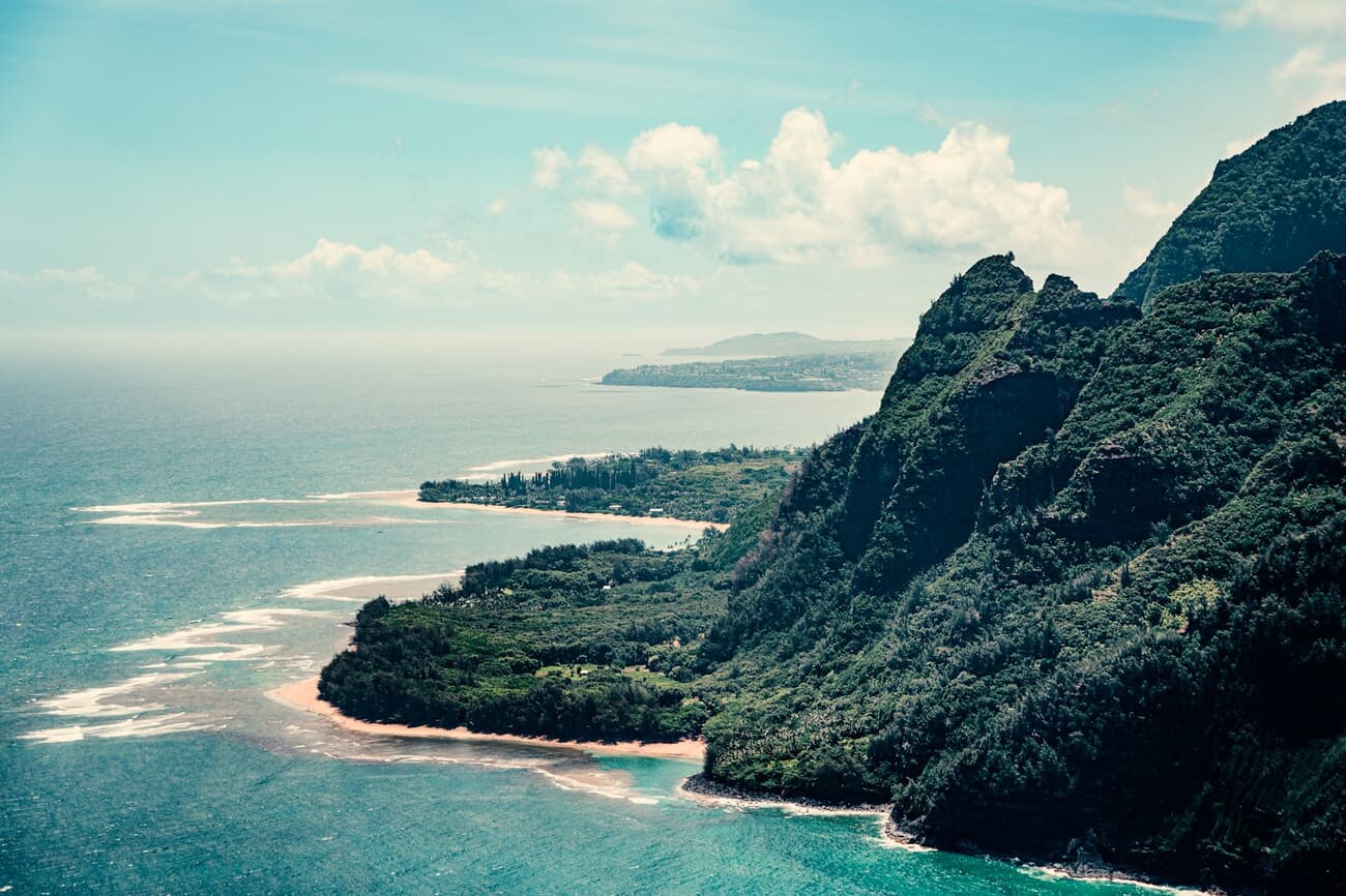 The fluted cliffs of the Napali Coast drop into turquoise water on Kauai's north shore