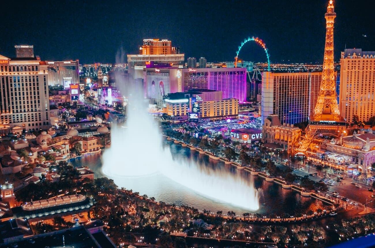 The Bellagio fountains erupt in front of the neon sprawl of the Las Vegas Strip