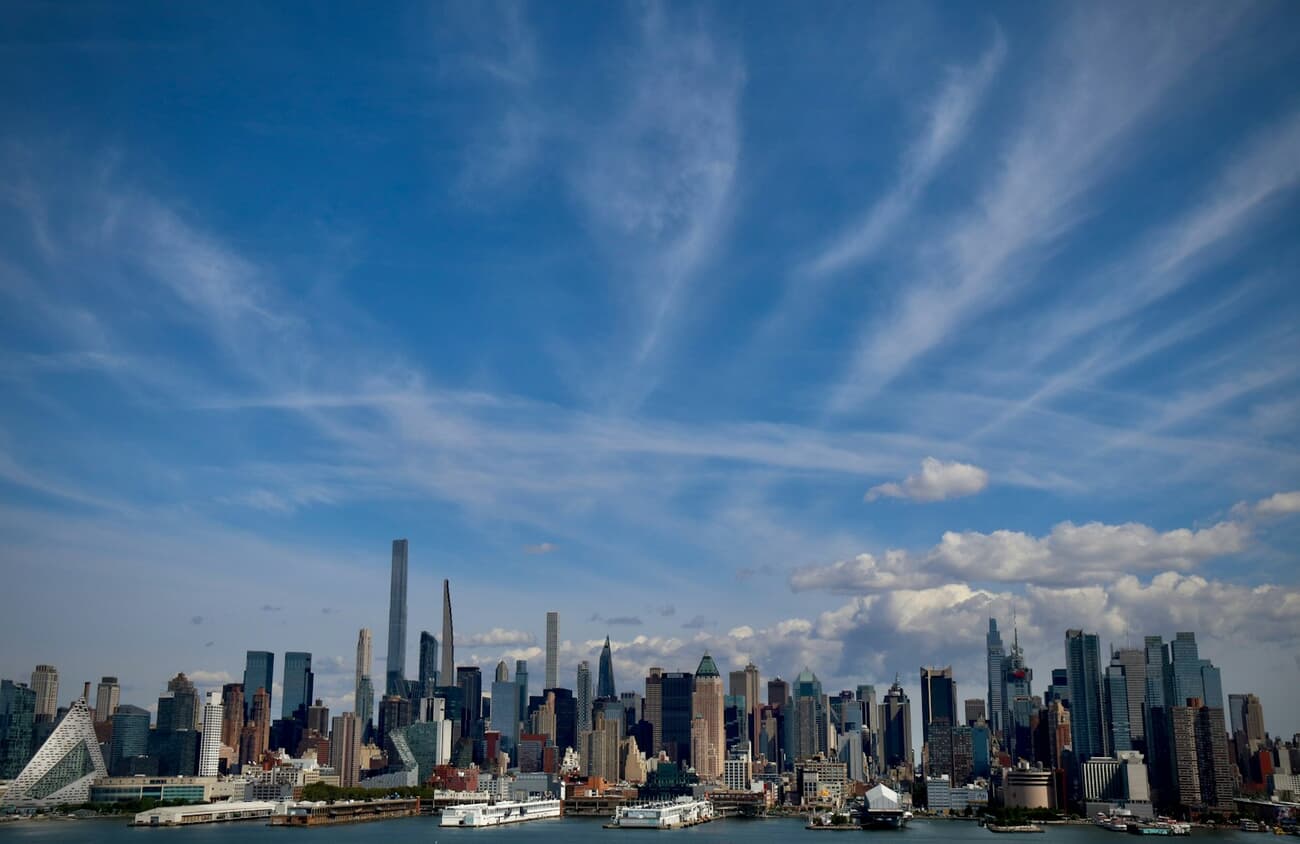 The Manhattan skyline stacks up over the Hudson River, the classic first view of New York City