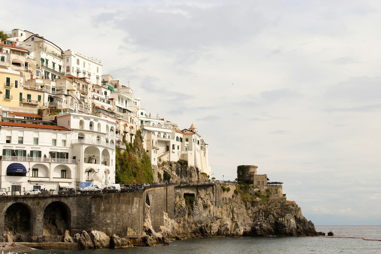 Pastel houses stack above the harbor along Italy's Amalfi Coast