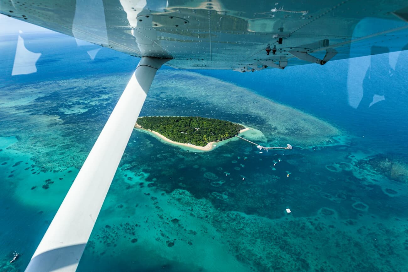 The Great Barrier Reef spreads beneath a light aircraft off Queensland, Australia