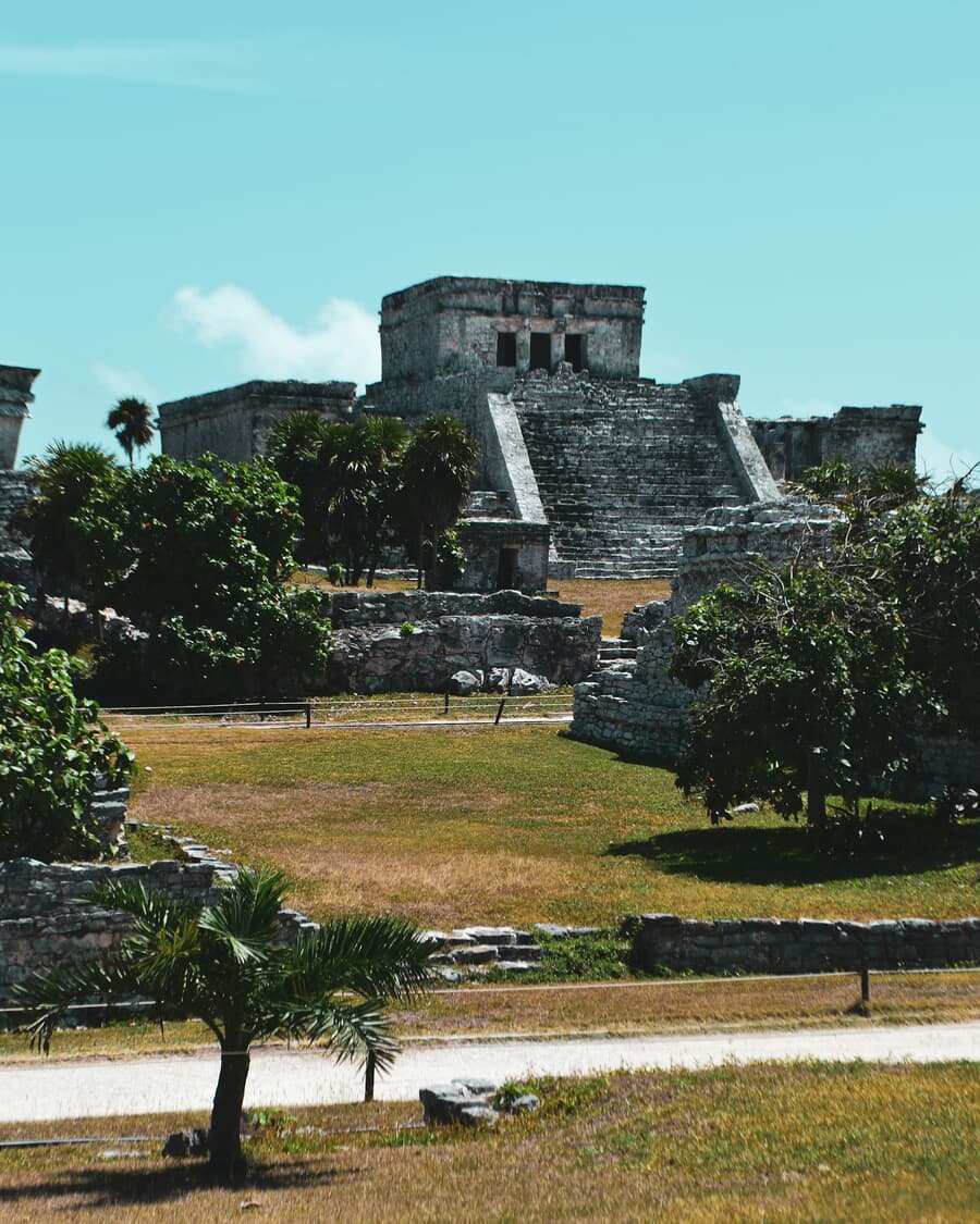The Mayan temple of El Castillo stands above the palms at the Tulum archaeological site, Mexico