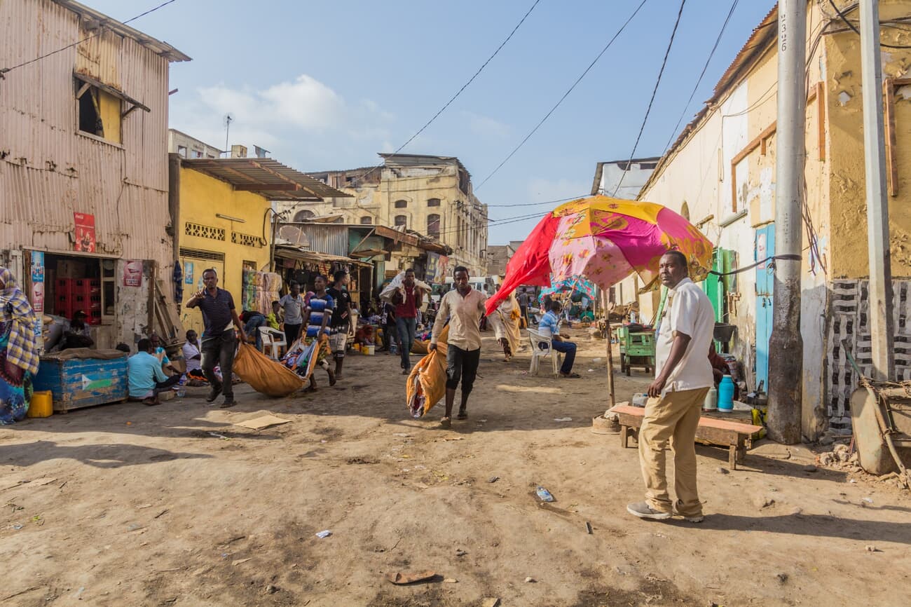 A bustling street scene in Djibouti with pedestrians and shops