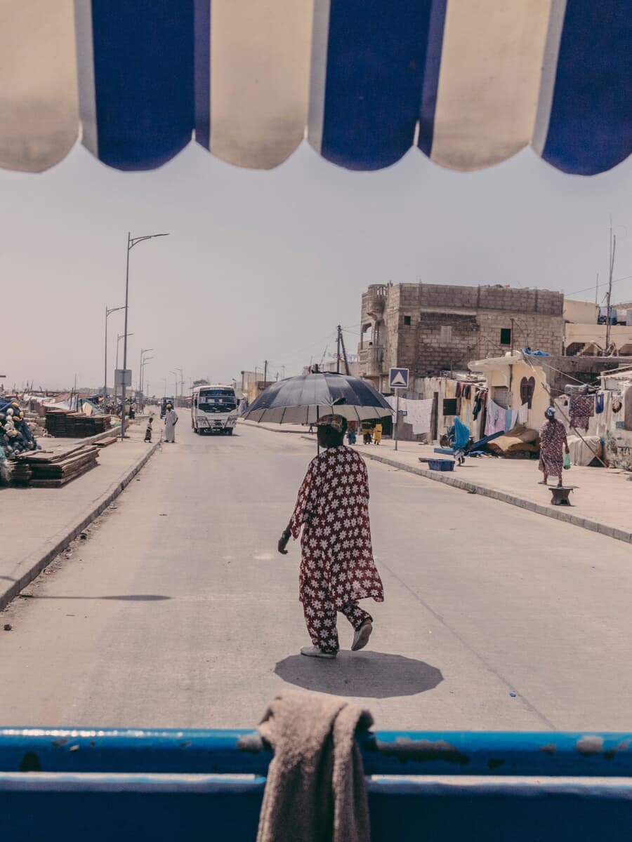A person walking on a street in Saint-Louis, Senegal
