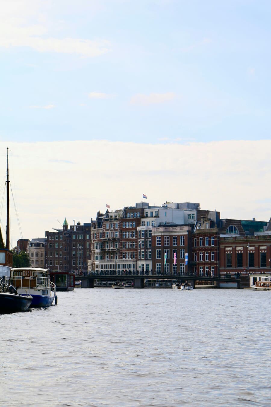 Brick Facades by the Canal: Boats and Bridge in a Quiet Waterfront Skyline