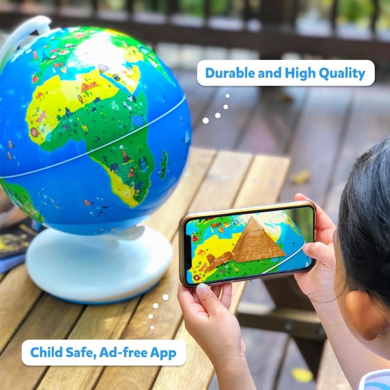 A child pointing a phone at the Orboot Earth globe as an augmented-reality pyramid appears on screen