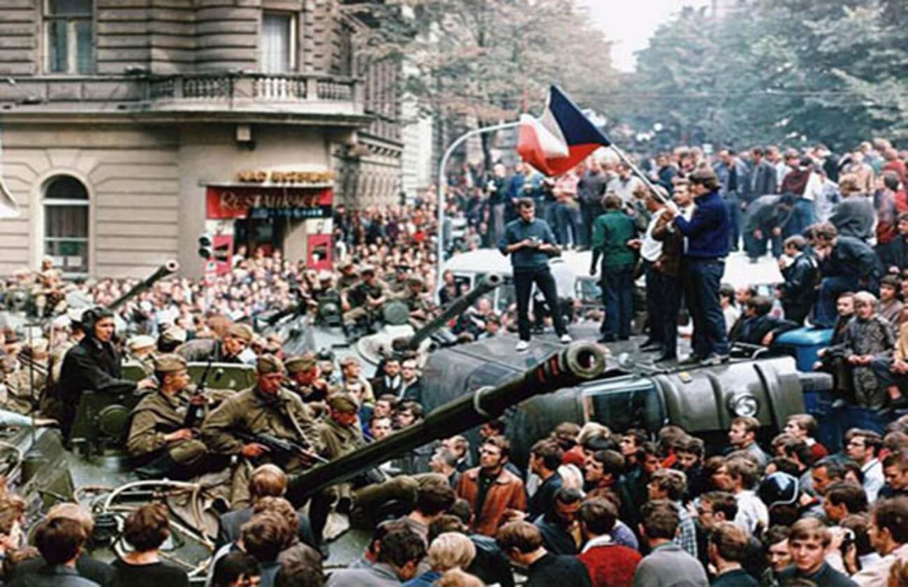 Soviet tanks in a Prague street surrounded by crowds during the 1968 Warsaw Pact invasion