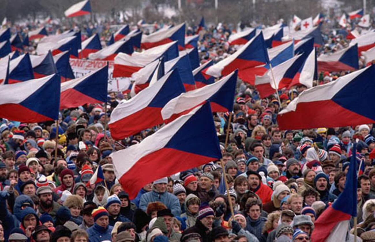 A large crowd waving many Czechoslovak flags during the 1989 demonstrations