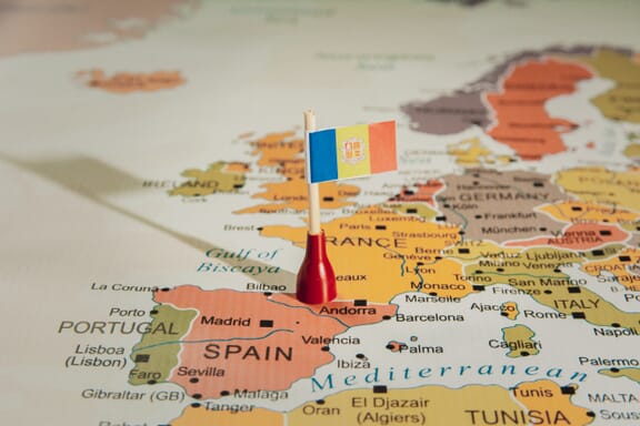 Flag pin pointing out the location of Andorra on the Europe map