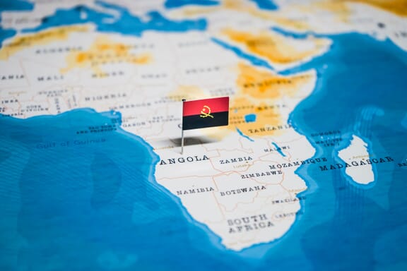 Flag pin pointing out the location of Angola on the Africa map