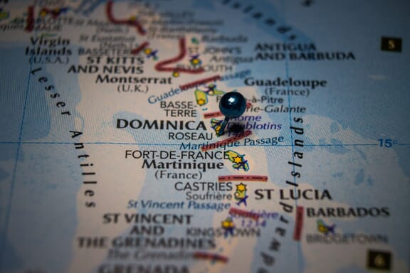 Flag pin pointing out the location of Dominica on the Caribbean Map