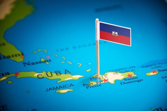 Flag pin pointing out the location of Haiti on the Central America map