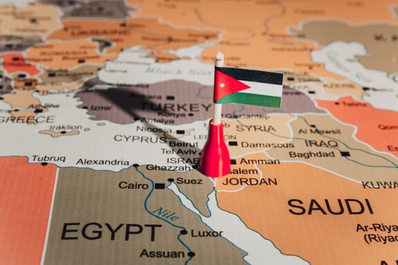 Flag pin pointing out the location of Jordan on the Middle East map