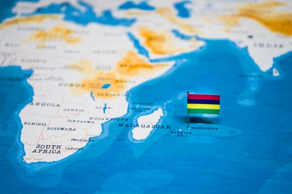 Flag pin pointing out the location of Mauritius on the Africa map