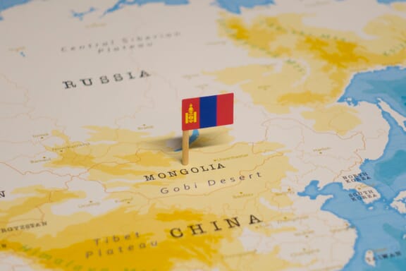 Flag pin pointing out the location of Mongolia on the Asia map
