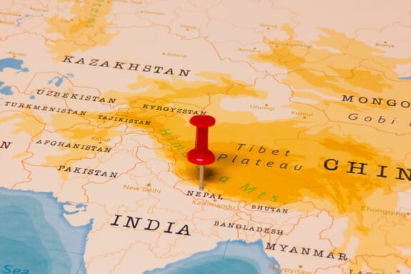 Pin pointing out the location of Nepal on the Asia map
