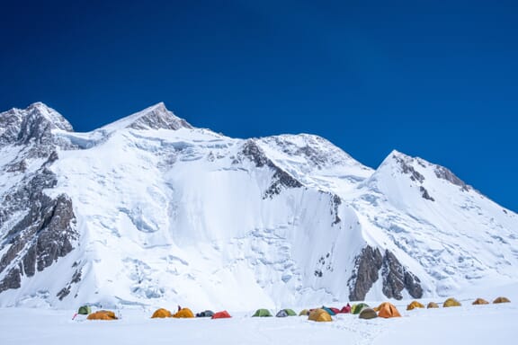 Colorful tents sit on the snow at Camp I of Gasherbrum II, one of the highest mountains in the world. Colorful tents sit on the snow at Camp I of Gasherbrum II, one of the highest mountains in the world.