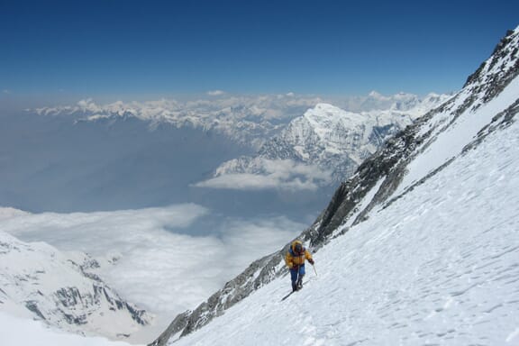 A climber makes his or her way up the snow-covered side of Dhaulagiri.