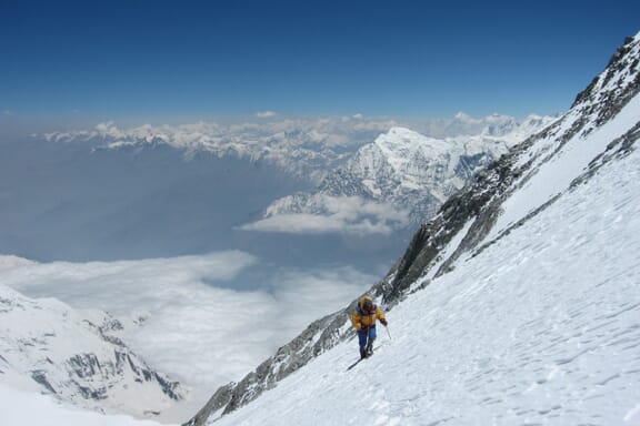 A climber makes his or her way up the snow-covered side of Dhaulagiri. A climber makes his or her way up the snow-covered side of Dhaulagiri.
