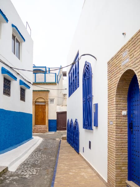 A typical street lined with blue and white buildings in the Kasbah of the Udayas. A typical street lined with blue and white buildings in the Kasbah of the Udayas.