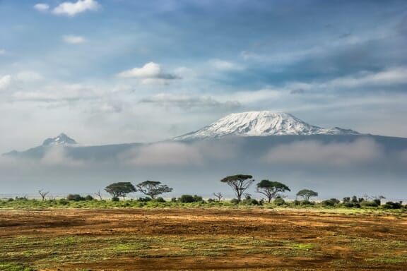 Snow-covered Mount Kilimanjaro can be seen from Amboseli National Park in Kenya. Snow-covered Mount Kilimanjaro can be seen from Amboseli National Park in Kenya.