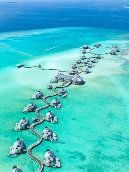 An aerial view of a resort extending into the water at Noonu Atoll in the Maldives, one of the countries on the equator. An aerial view of a resort extending into the water at Noonu Atoll in the Maldives, one of the countries on the equator.