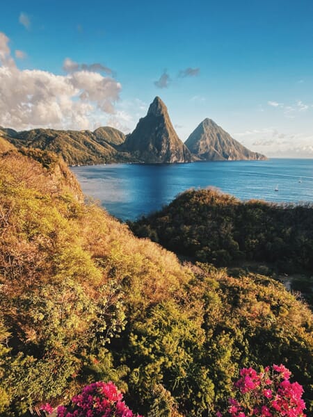 A bay is surrounded by golden hills on the main island of Saint Lucia.