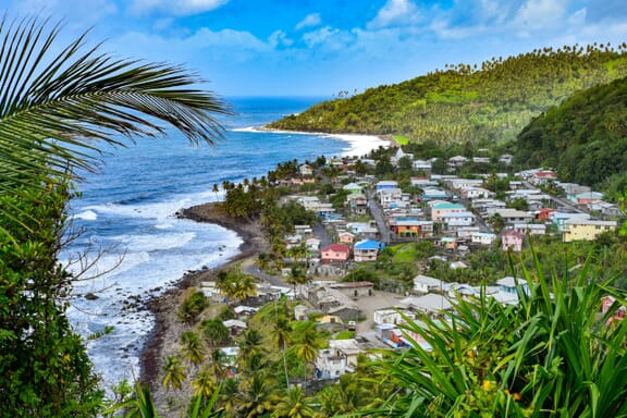 A small town sits back from the shore on an island in Saint Vincent and the Grenadines. A small town sits back from the shore on an island in Saint Vincent and the Grenadines.