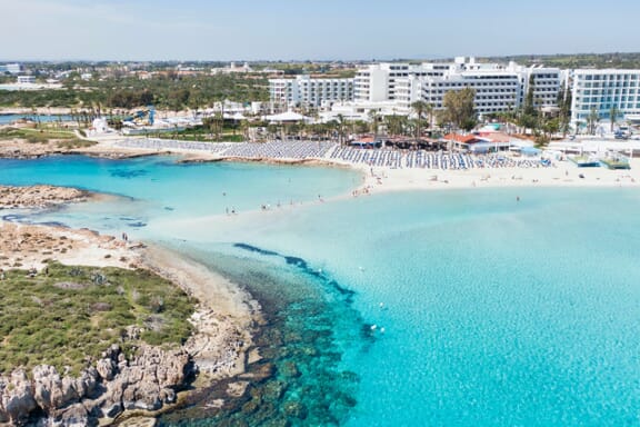 Clear blue waters border a white-sand beach in Ayia Napa, Cyprus.