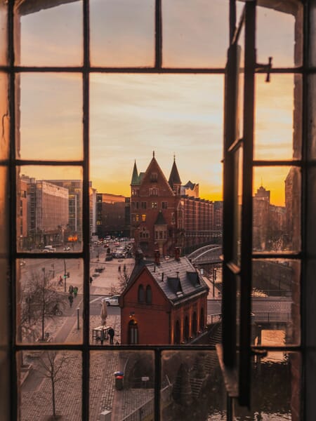 Hamburg, Germany seen though an open window at sunset. Hamburg, Germany seen though an open window at sunset.