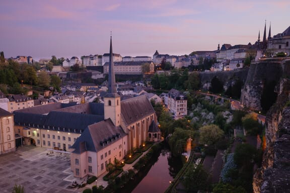 A church sits next to the water in Luxembourg City, Luxembourg.