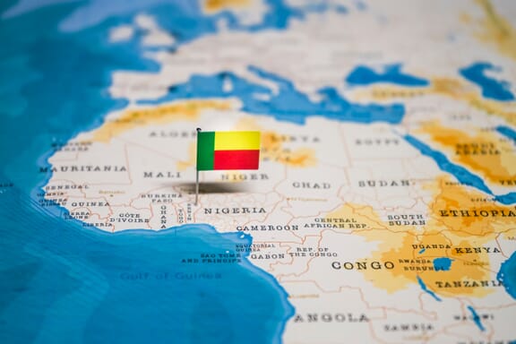 Benin pointed out on the map by a flag pin.