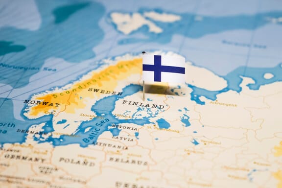 Finland pointed out on the map by a flag pin.