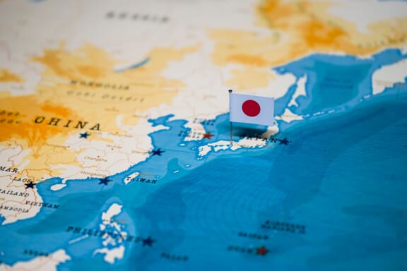 Japan pointed out on the map by a flag pin.