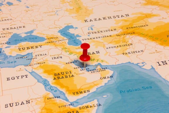 Pin pointing out the Qatar on a map.