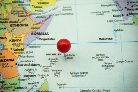 Pin pointing out Seychelles on a map.