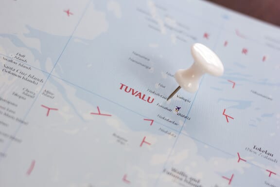 Pin pointing out Tuvalu on a map.