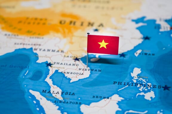 Vietnam pointed out on the map by a flag pin.
