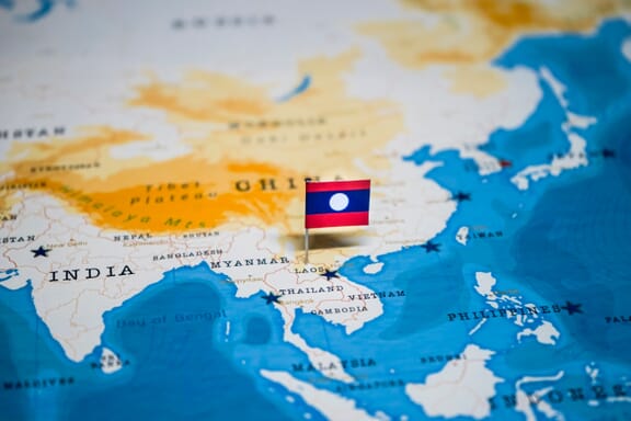 Laos location on the map pointed out by a flag pin.